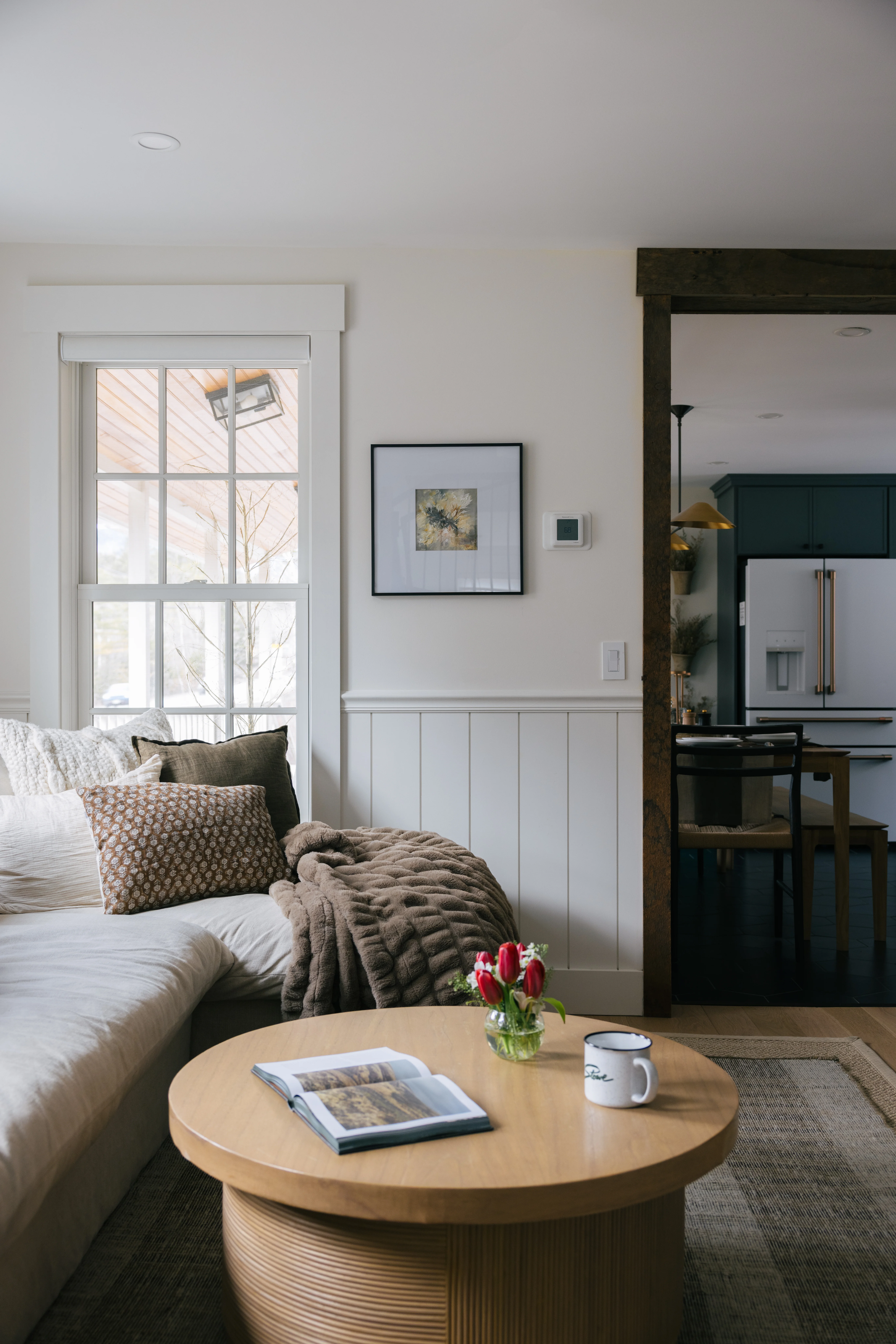 Second living room angle highlighting the seating arrangement, fireplace surround, and open-plan layout